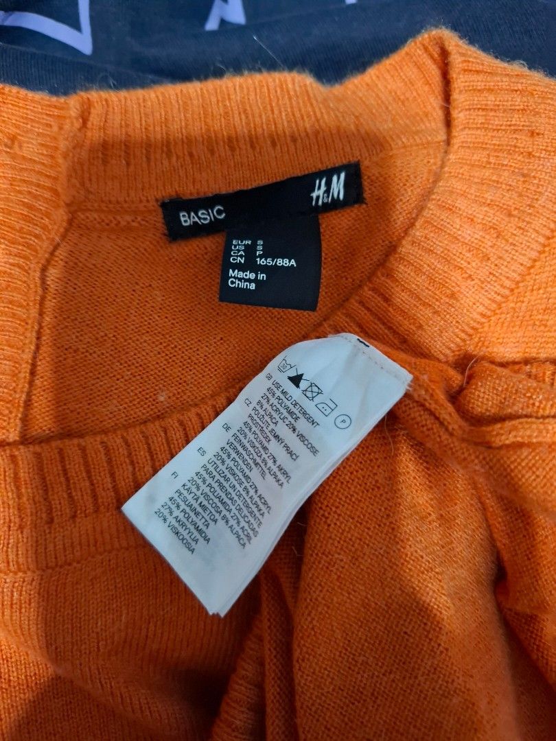 H&M Basic Orange Knit Sweater Size S (Category: Longsleeves) located in Manila. Submitted by jazil.ladyliz (Listing ID 1464074272, Image 3). Description: - H&M Basic orange knit sweater - Long sleeves and round neckline - Small button detail at the collar - Material: Acrylic, Polyamide, Alpaca blend - Comfortable and warm for cooler weather - Ideal for layering.