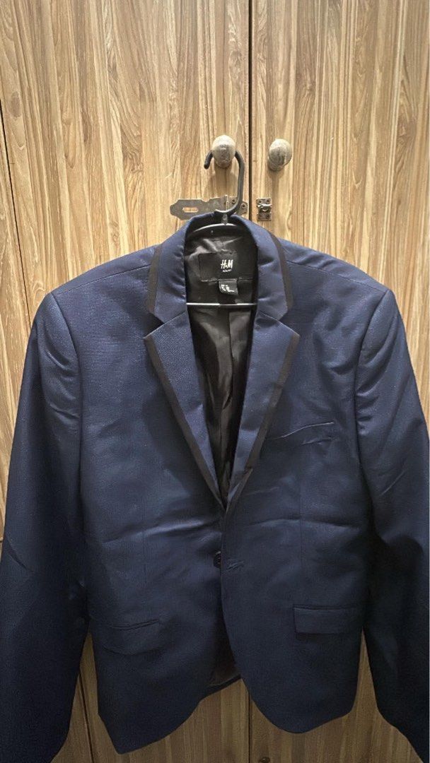 H&M Navy Blue Blazer with Black Lapels EU 50 (Category: Coats, Jackets and Outerwear) located in Manila. Submitted by kedno (Listing ID 1464045439, Image 1). Description: - Navy blue H&M blazer - Shiny textured fabric - Black satin lapels - Single button closure - Chest pocket and two front flap pockets - Fully lined interior - Ideal for formal events or elevating your look.