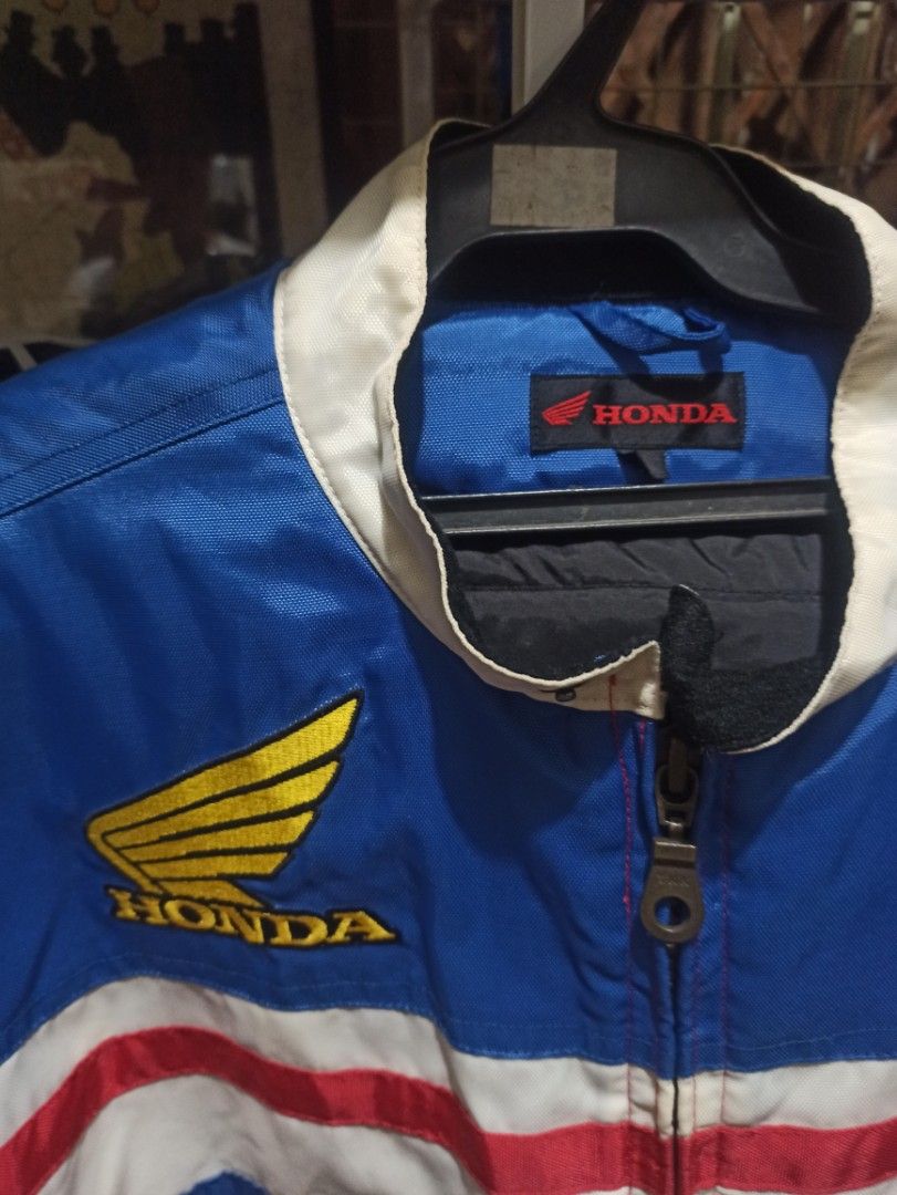 Honda Racing Vintage Jacket (Category: Coats, Jackets and Outerwear) located in Manila. Submitted by avrilarqu43176 (Listing ID 1463942946, Image 3). Description: - Vintage Honda racing jacket - Classic blue, red, and white colorway - Features iconic Honda wing logo on chest - 'HONDA' text on sleeves and back - Full zipper closure - Ideal for Honda enthusiasts and motorcycle riders.