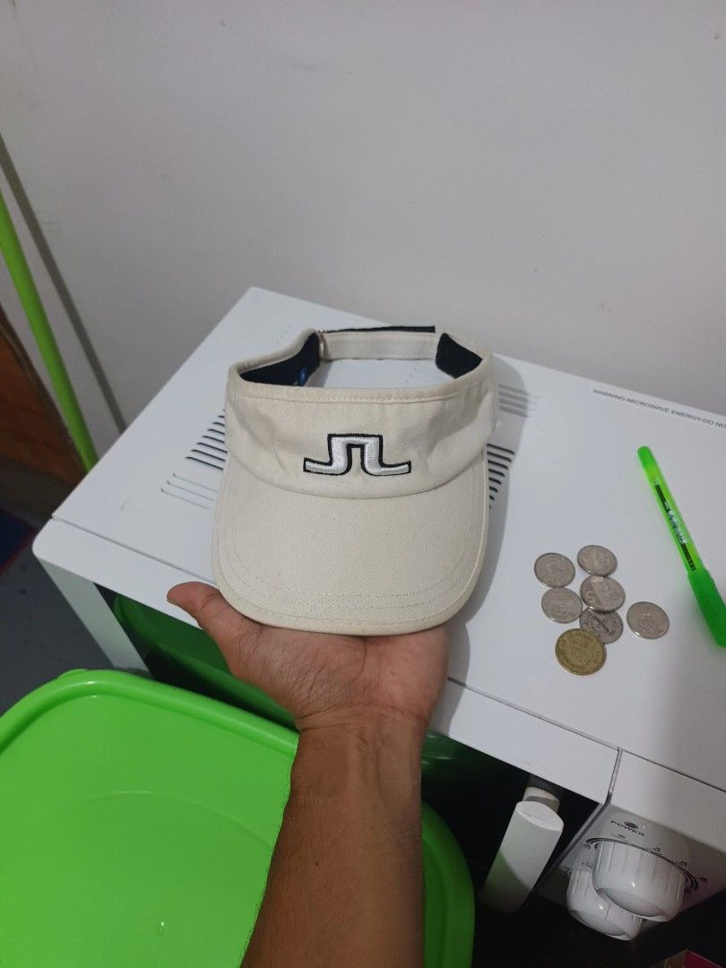 J. Lindeberg Golf Visor Beige One Size (Category: Caps & Hats) located in Irosin. Submitted by whanchore55263 (Listing ID 1463946150, Image 1). Description: - Brand: J. Lindeberg - Type: Golf Visor - Color: Beige with Black Trim - Features: Embroidered J. Lindeberg logo on front - Material: 100% Cotton - Size: One Size Fits Most - Ideal for: Sunny days on the golf course.