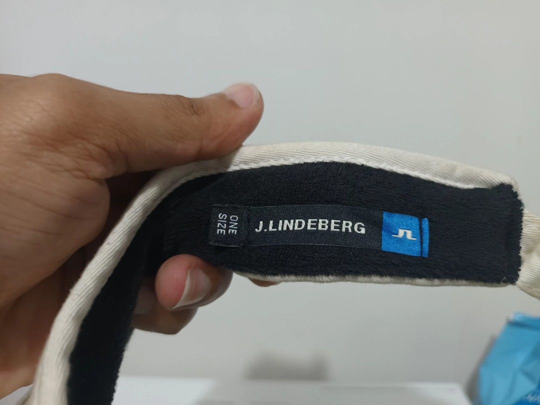 J. Lindeberg Golf Visor Beige One Size (Category: Caps & Hats) located in Irosin. Submitted by whanchore55263 (Listing ID 1463946150, Image 2). Description: - Brand: J. Lindeberg - Type: Golf Visor - Color: Beige with Black Trim - Features: Embroidered J. Lindeberg logo on front - Material: 100% Cotton - Size: One Size Fits Most - Ideal for: Sunny days on the golf course.