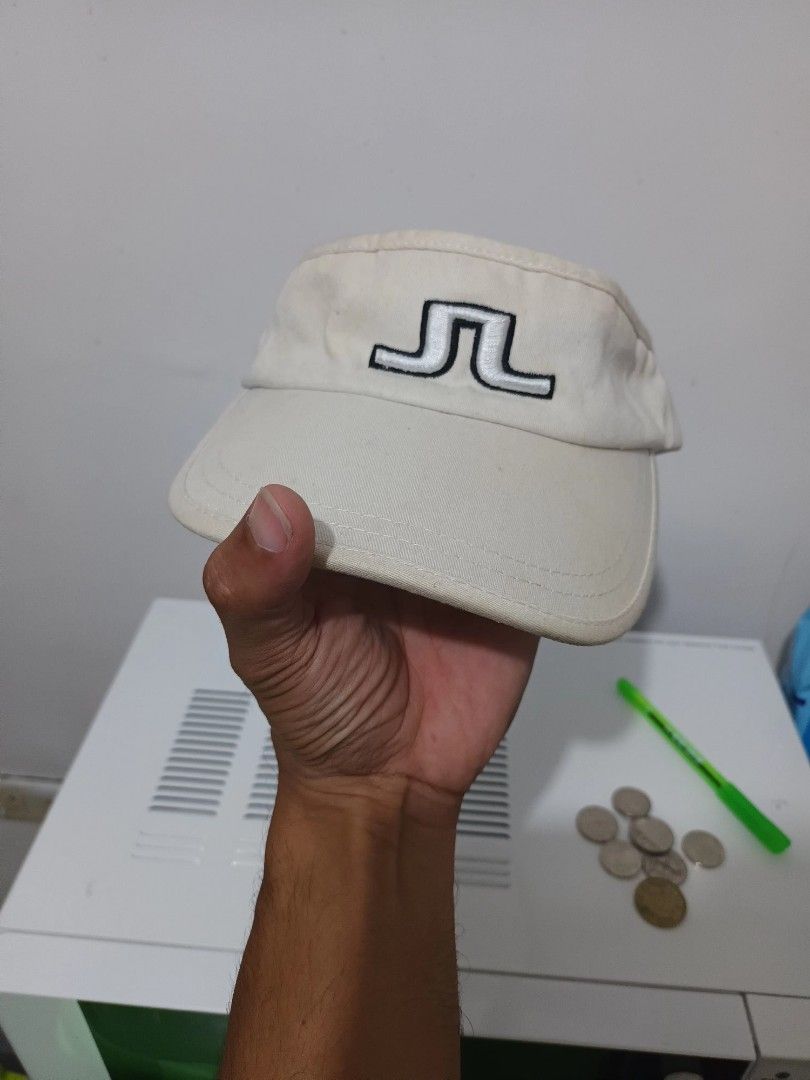 J. Lindeberg Golf Visor Beige One Size (Category: Caps & Hats) located in Irosin. Submitted by whanchore55263 (Listing ID 1463946150, Image 3). Description: - Brand: J. Lindeberg - Type: Golf Visor - Color: Beige with Black Trim - Features: Embroidered J. Lindeberg logo on front - Material: 100% Cotton - Size: One Size Fits Most - Ideal for: Sunny days on the golf course.