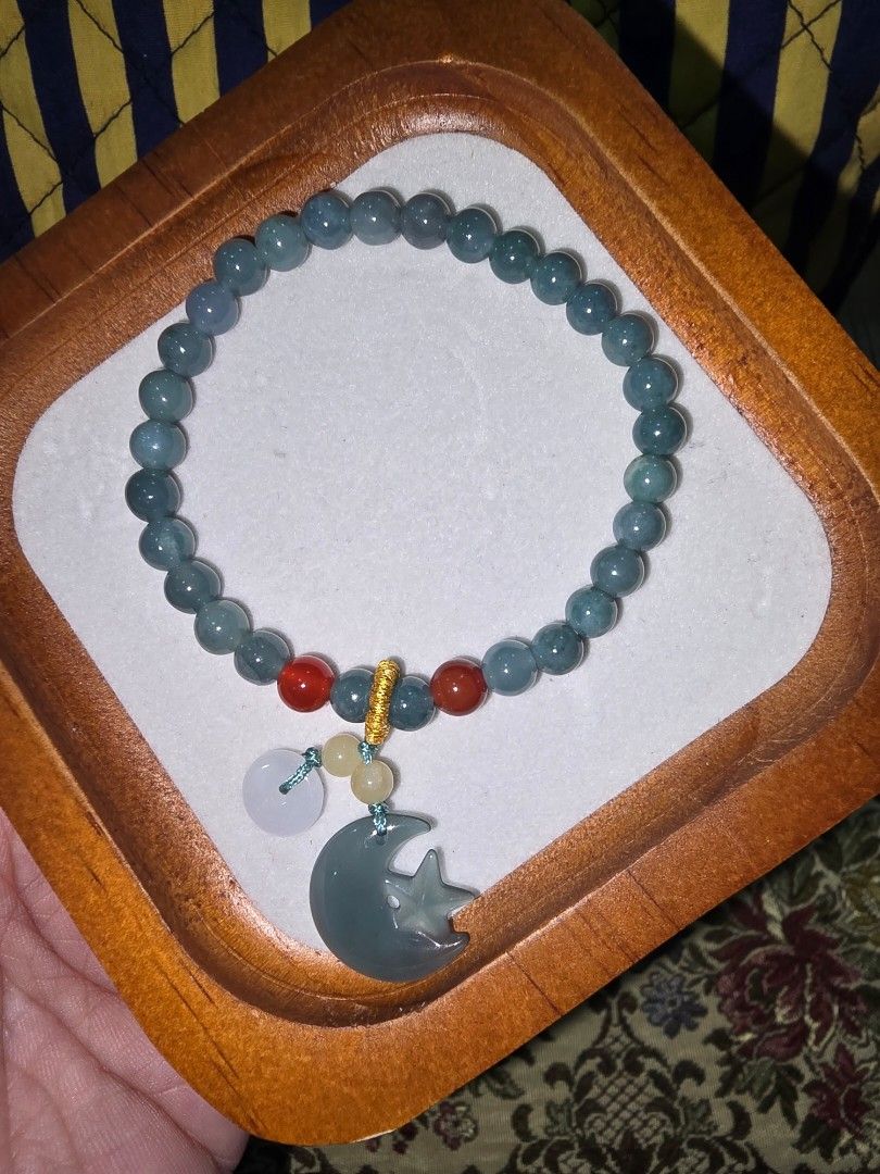 Jade Moon Charm Beaded Bracelet (Category: Bracelets) located in Santa Rosa. Submitted by crystal1.0 (Listing ID 1464003838, Image 1). Description: - Cute beaded bracelet - Features a jade moon charm - Accented with red and white stones - Stretchy band for easy wear - Unique and stylish accessory.