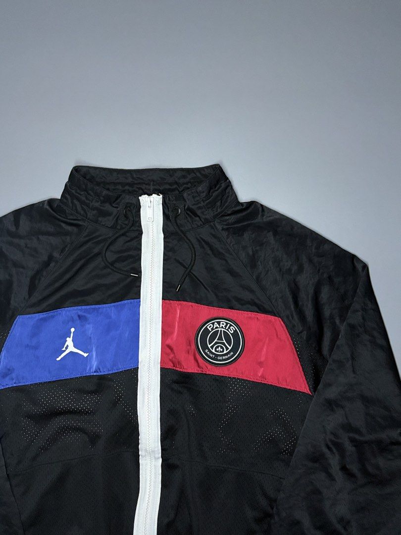 Jordan Paris Saint-Germain Track Jacket (Category: Coats, Jackets and Outerwear) located in Manila. Submitted by adroitamar51133 (Listing ID 1464029549, Image 1). Description: - Authentic Jordan x PSG track jacket - Features iconic Jumpman and Paris Saint-Germain logos - Bold blue and red color blocking on the front - 'PARIS' lettering with Jumpman logo on the back - Vibrant geometric pattern lining - Full zip closure - Elasticated cuffs and hem.