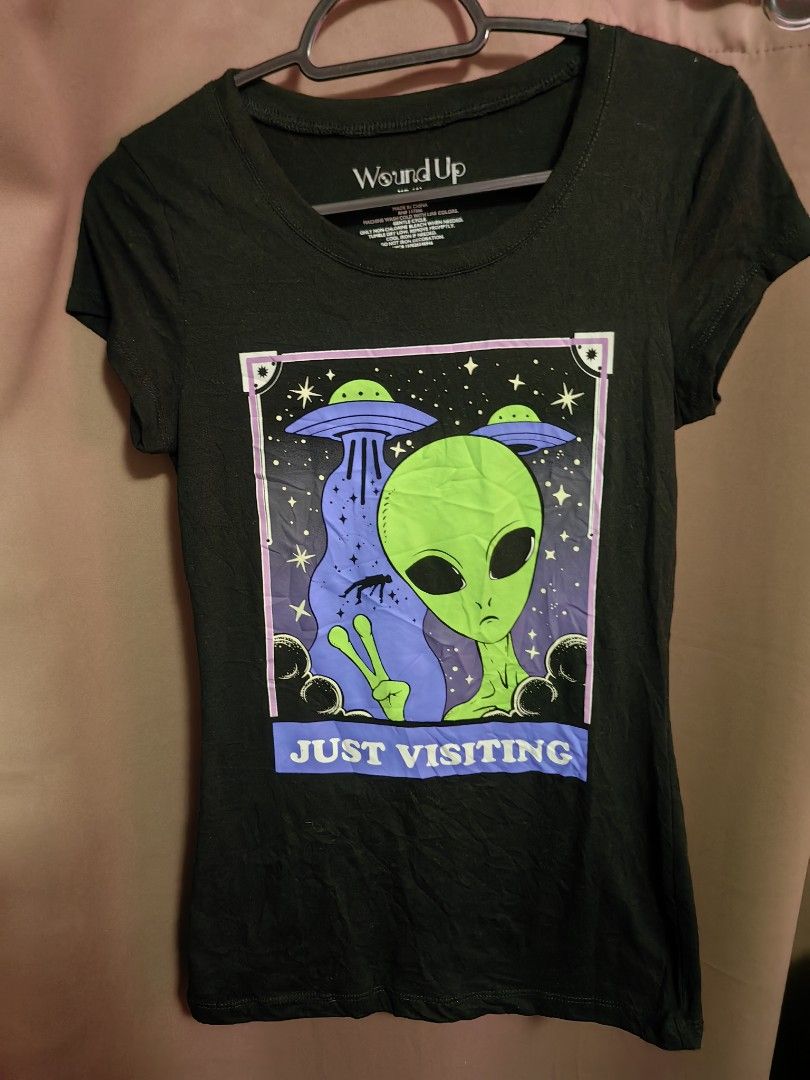 Just Visiting Alien Shirt (Category: Shirts) located in Malolos. Submitted by aemcloset (Listing ID 1464080900, Image 1). Description: Width 13 Length 25 Up to medium 34bust Cotton stretch.