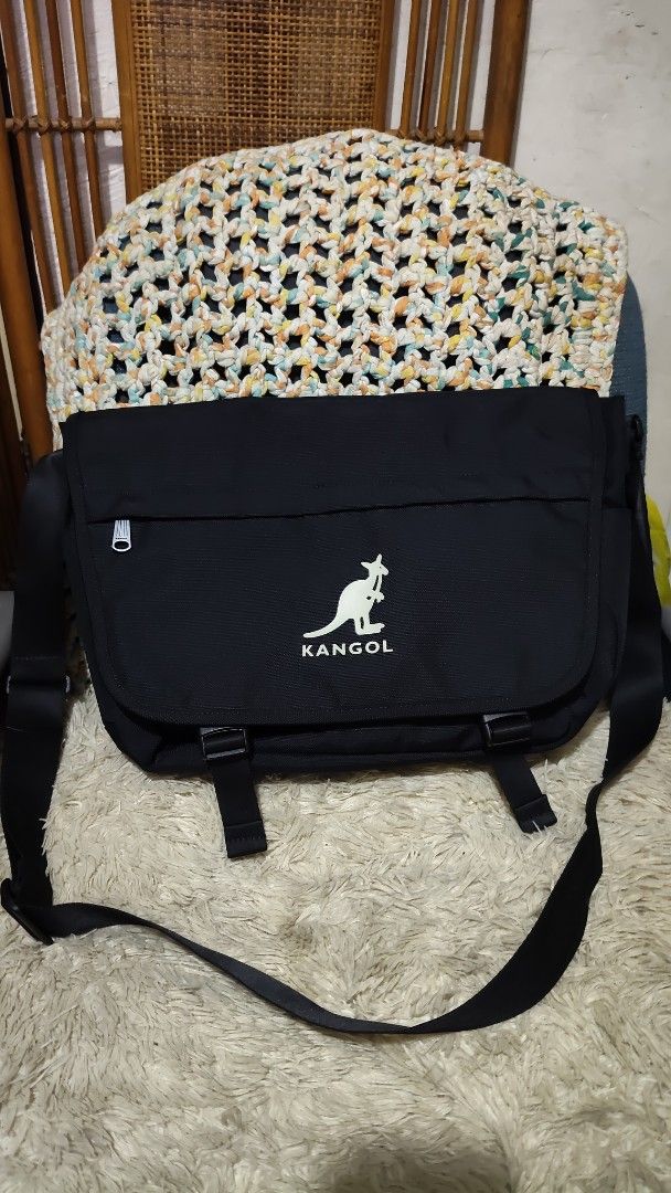 Kangol Black Messenger Bag (Category: Sling Bags) located in Cebu City. Submitted by lumaynojes00490 (Listing ID 1463958930, Image 1). Description: - Brand: Kangol - Color: Black - Iconic kangaroo logo on the front - Multiple interior compartments for organization - Adjustable strap for comfortable carrying - Ideal for daily use and travel.