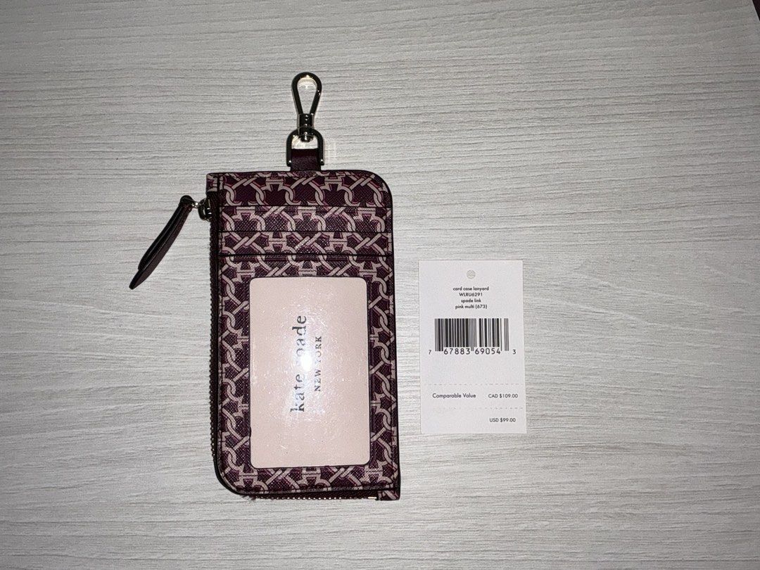 Kate Spade Card Case Lanyard Pink Multi (Category: Wallets & Card holders) located in San Juan City. Submitted by herdaintyfinds (Listing ID 1463962280, Image 3). Description: - Kate Spade card case with lanyard - Signature interlocking monogram print in pink multi - Zippered compartment for coins or cards - Clear window for ID - Detachable lanyard included - Perfect for keeping essentials handy.
