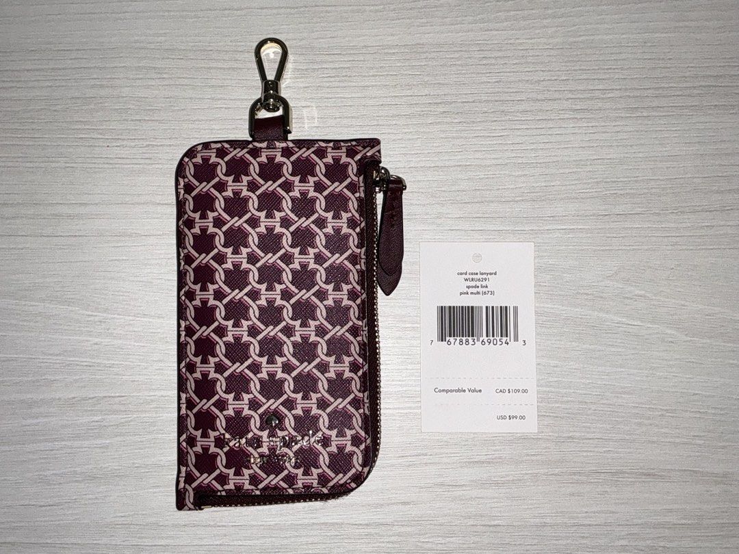 Kate Spade Card Case Lanyard Pink Multi (Category: Wallets & Card holders) located in San Juan City. Submitted by herdaintyfinds (Listing ID 1463962280, Image 2). Description: - Kate Spade card case with lanyard - Signature interlocking monogram print in pink multi - Zippered compartment for coins or cards - Clear window for ID - Detachable lanyard included - Perfect for keeping essentials handy.
