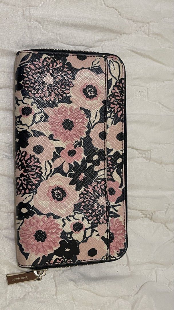 Kate Spade Floral Zip Around Wallet (Category: Wallets & Card holders) located in Manila. Submitted by heyuzlh (Listing ID 1464104137, Image 2). Description: - Cute Kate Spade wallet - Pink and black floral print - Zip around closure - Multiple interior card slots - Zippered coin pocket - Ample space for essentials - Gold tone hardware -minimal yellow stain (as shown in the pics) .