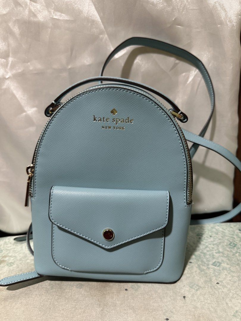 Kate Spade New York Light Blue Leather Backpack (Category: Backpacks) located in Balanga. Submitted by jk2025. (Listing ID 1463953233, Image 1). Description: - Cute light blue Kate Spade backpack - Features a front pocket with snap closure - Adjustable straps for comfortable wear - Elegant gold hardware details - Ideal for everyday use or travel - Clean inside and out, ready for its new home!.