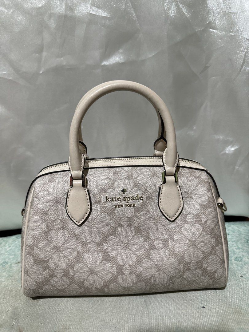 Kate Spade New York Monogram Dome Satchel (Category: Shoulder Bags) located in Balanga. Submitted by jk2025. (Listing ID 1463951533, Image 1). Description: - Authentic Kate Spade dome satchel - Classic beige and cream monogram print - Structured design with top handles - Ideal size for everyday essentials - Interior is clean and well-maintained - Comes with a detachable strap for versatile carrying.
