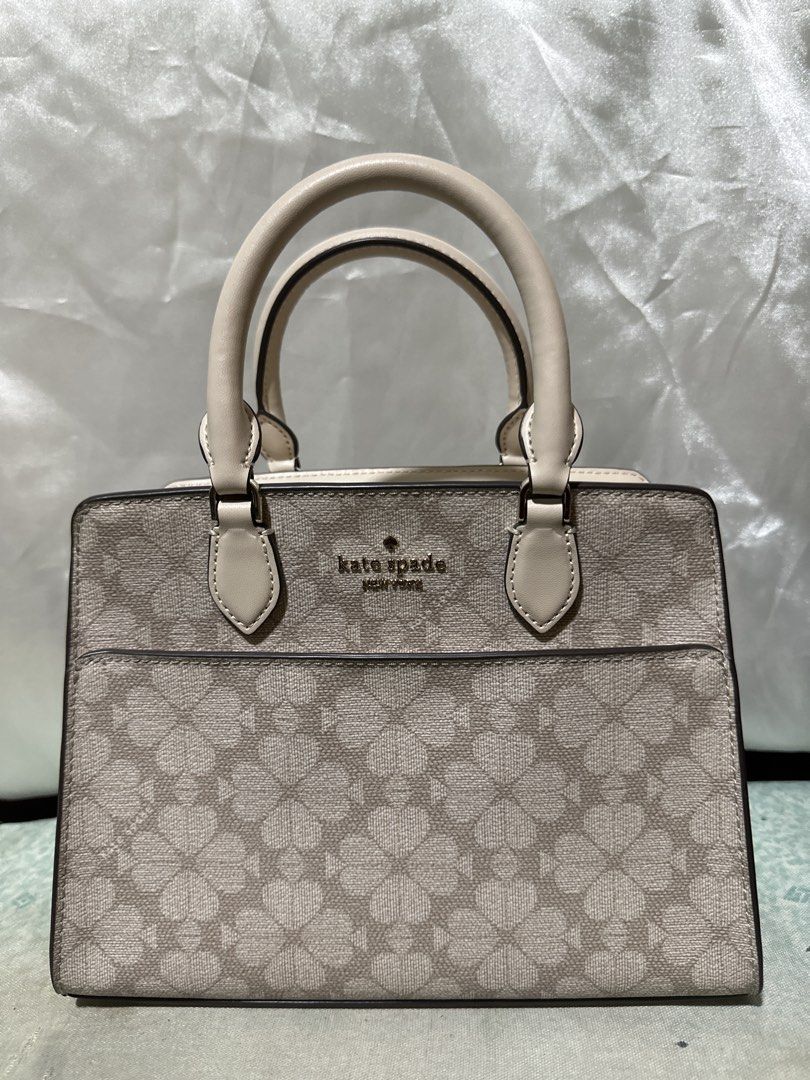 Kate Spade New York Monogram Handbag (Category: Shoulder Bags) located in Balanga. Submitted by jk2025. (Listing ID 1463950909, Image 1). Description: - Authentic Kate Spade handbag - Signature spade monogram print - Chic beige and cream colorway - Structured design with top handles - Versatile for everyday or evening wear - Clean interior - Comes with original dust bag.