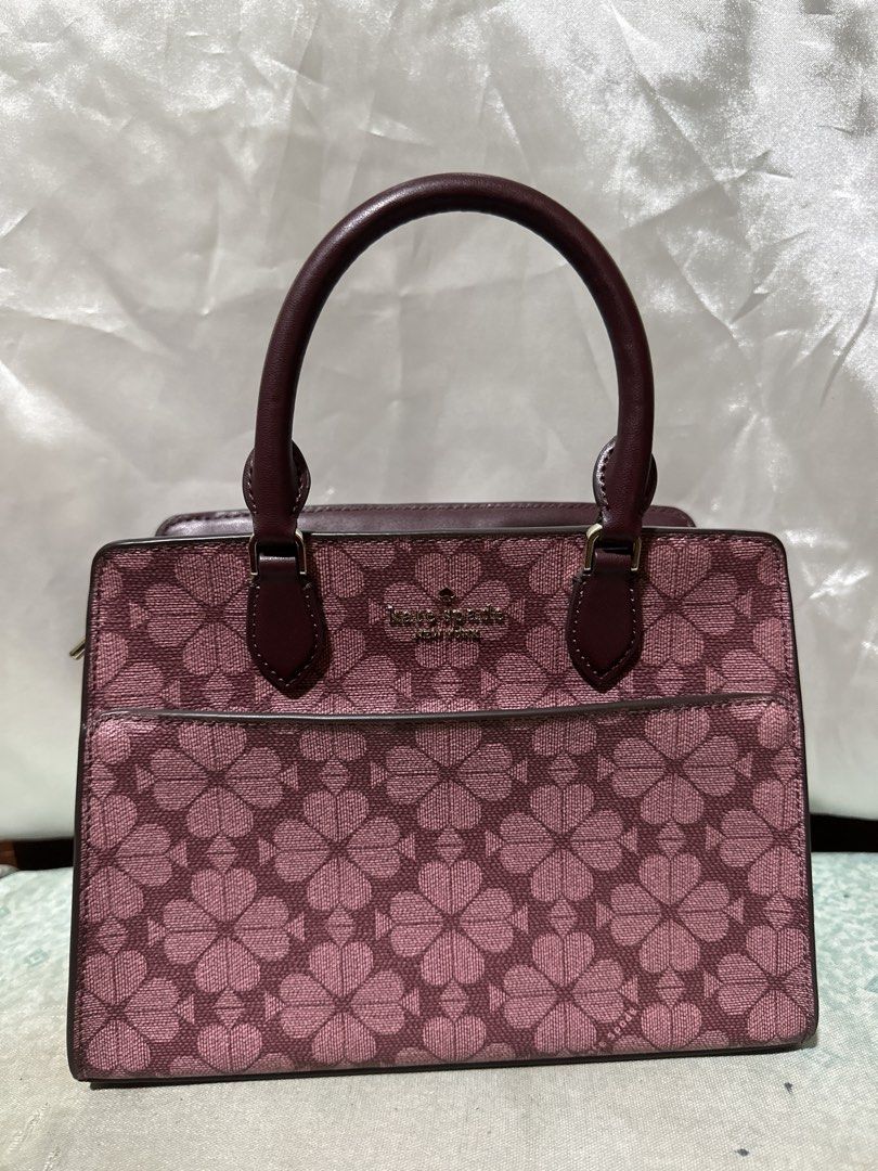 Kate Spade Pink Clover Print Top Handle Bag (Category: Shoulder Bags) located in Balanga. Submitted by jk2025. (Listing ID 1463951269, Image 1). Description: - Adorable Kate Spade top handle bag - Features signature pink clover print - Chic burgundy leather trim and handles - Secure zipper closure - Versatile for everyday use or evening outings - Spacious interior.