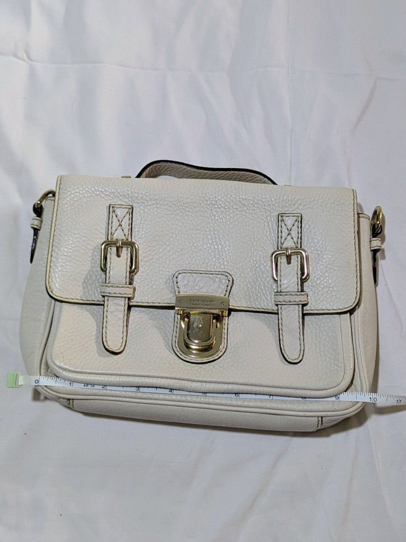 Kate Spade White Leather Satchel Bag (Category: Luxury Bags & Wallets) located in Quezon City. Submitted by kuripotnya (Listing ID 1464062891, Image 1). Description: - Brand: Kate Spade - Material: White pebbled leather - Hardware: Gold - Closure: Clasp - Interior: Striped lining with zip pocket - Straps: Top handle and optional shoulder strap (included) - Dimensions: Approx. 10 inches wide - can fit ipad/tablets - preloved excellent condition 9/