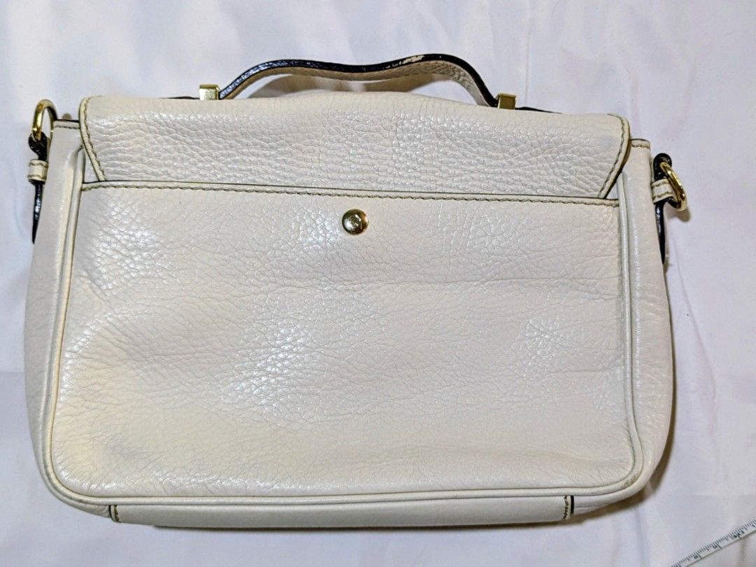 Kate Spade White Leather Satchel Bag (Category: Luxury Bags & Wallets) located in Quezon City. Submitted by kuripotnya (Listing ID 1464062891, Image 3). Description: - Brand: Kate Spade - Material: White pebbled leather - Hardware: Gold - Closure: Clasp - Interior: Striped lining with zip pocket - Straps: Top handle and optional shoulder strap (included) - Dimensions: Approx. 10 inches wide - can fit ipad/tablets - preloved excellent condition 9/