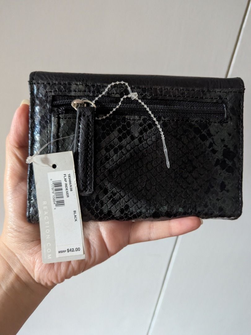 Kenneth Cole Reaction Black Snake Print Tri-Fold Wallet (Category: Wallets & Card holders) located in Quezon City. Submitted by kuripotnya (Listing ID 1463996764, Image 2). Description: - Brand: Kenneth Cole Reaction - Color: Black - Style: Tri-fold wallet - Exterior/Interior Detail: Snake print - Features: Multiple card slots, zippered coin pocket - Closure: Snap closure - Condition: Brand new with original tag attached - Original Retail Price: 