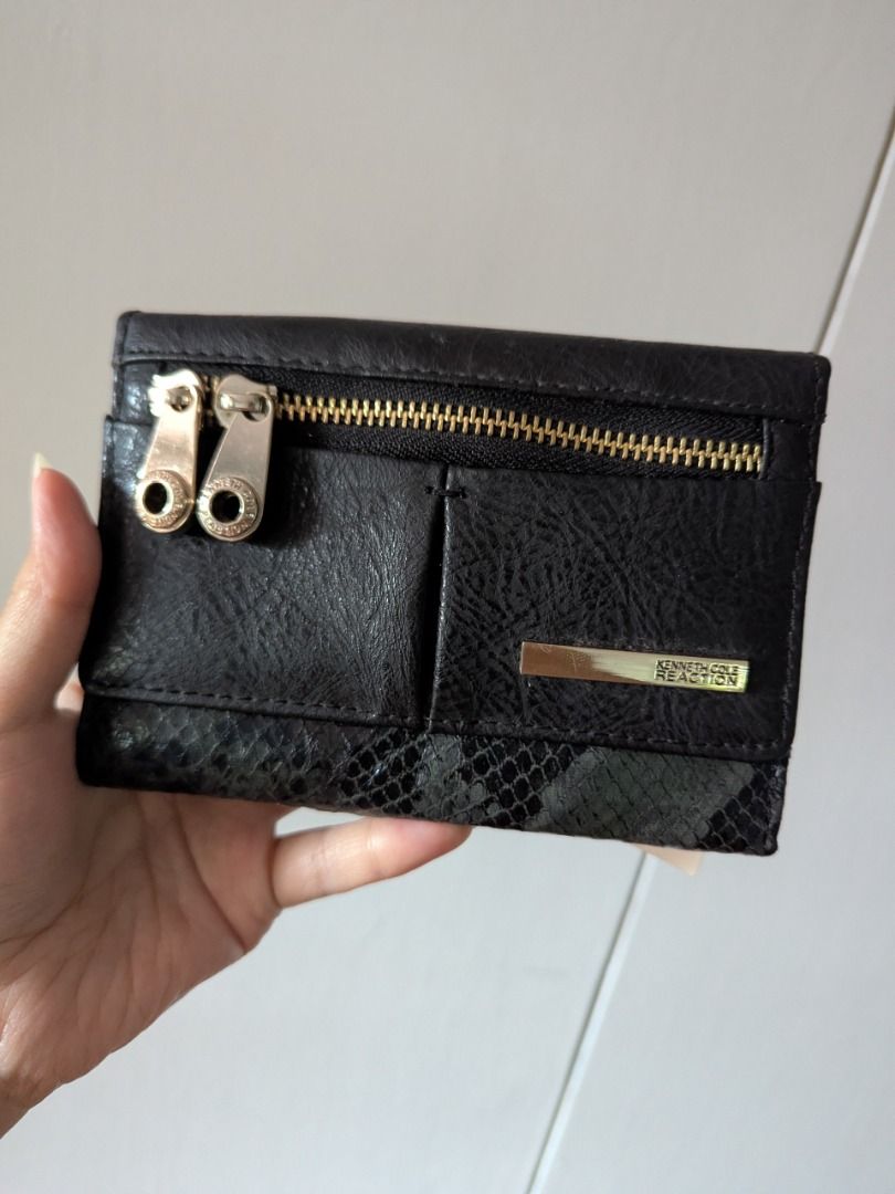 Kenneth Cole Reaction Black Snake Print Tri-Fold Wallet (Category: Wallets & Card holders) located in Quezon City. Submitted by kuripotnya (Listing ID 1463996764, Image 1). Description: - Brand: Kenneth Cole Reaction - Color: Black - Style: Tri-fold wallet - Exterior/Interior Detail: Snake print - Features: Multiple card slots, zippered coin pocket - Closure: Snap closure - Condition: Brand new with original tag attached - Original Retail Price: 