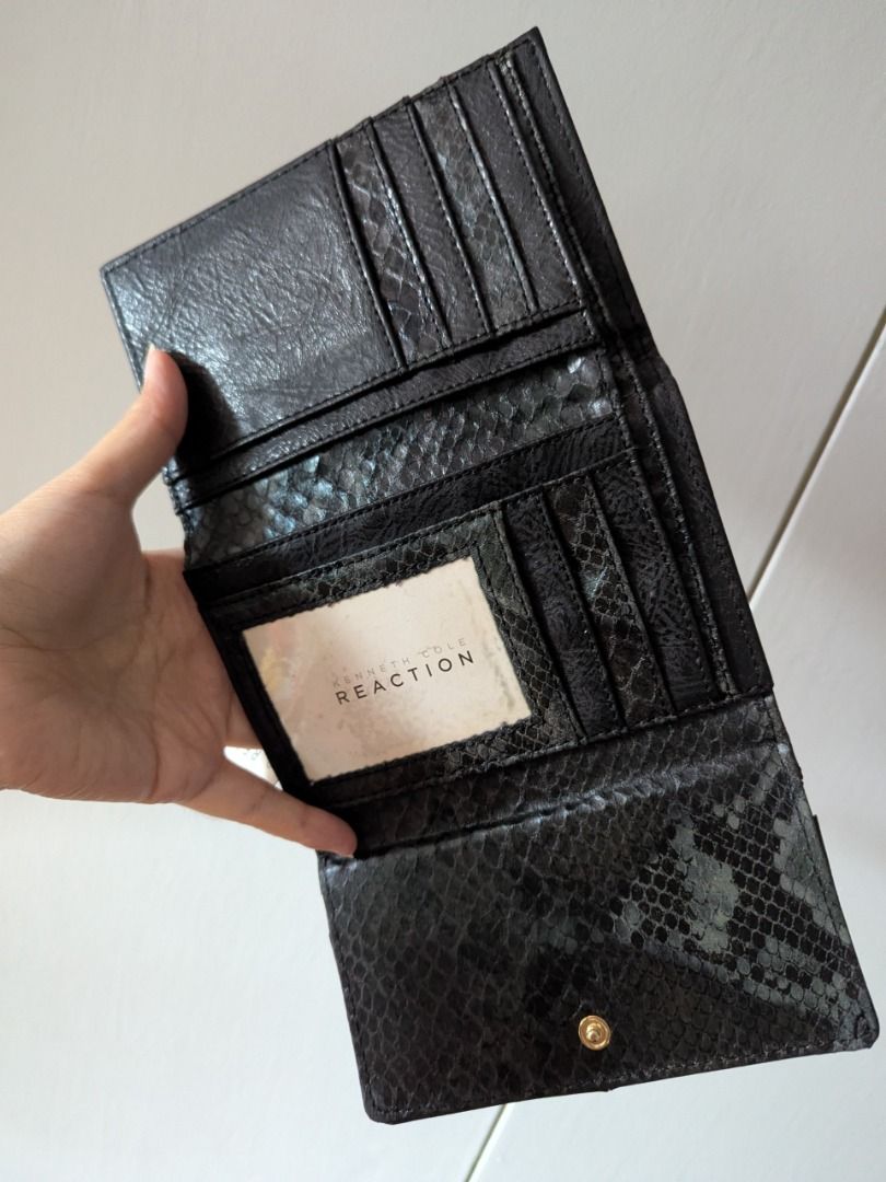 Kenneth Cole Reaction Black Snake Print Tri-Fold Wallet (Category: Wallets & Card holders) located in Quezon City. Submitted by kuripotnya (Listing ID 1463996764, Image 3). Description: - Brand: Kenneth Cole Reaction - Color: Black - Style: Tri-fold wallet - Exterior/Interior Detail: Snake print - Features: Multiple card slots, zippered coin pocket - Closure: Snap closure - Condition: Brand new with original tag attached - Original Retail Price: 