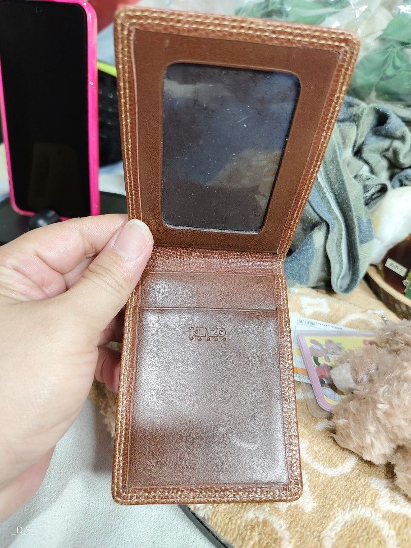 KENZO Paris Brown Leather Card Holder (Category: Wallets & Card holders) located in Lucena. Submitted by dai_suki (Listing ID 1464042047, Image 3). Description: - Genuine KENZO Paris brown leather card holder - One side features a clear window slot for easy ID/card visibility - Additional slot on the other side for extra cards - Subtle embossed KENZO logo on the front - Ideal for keeping your essential cards neatly organized.