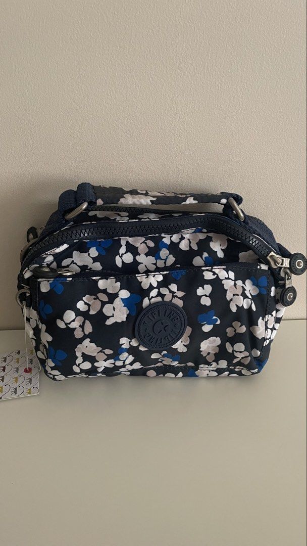 Kipling crossbody bag with monkey charm and adjustable long strap (Category: Cross-body Bags) located in Makati City. Submitted by sellonlineph (Listing ID 1463216468, Image 3). Description: - Cute Kipling crossbody bag - Great prints - Signature monkey charm included - Long, adjustable strap for comfort. Can be carried as handbag, shoulder bag, or crossbody. - Multiple interior pockets for organization - Secure zip-top closure - Ideal for everyd