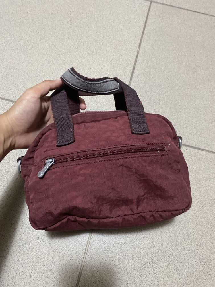 Kipling Maroon (Category: Shoulder Bags) located in Dagupan City. Submitted by maryennie (Listing ID 1464001833, Image 2). Description: Working zippers (all) Spacious interior Suitable for work, daily use or travel -Condition: Pre-loved, with visible signs of use , surface scratches/scuffs and some wear on the silver hardware. Please refer to photos for exact condition. ⭐️Selling as-is. Please inspect photos carefully before purchasing..