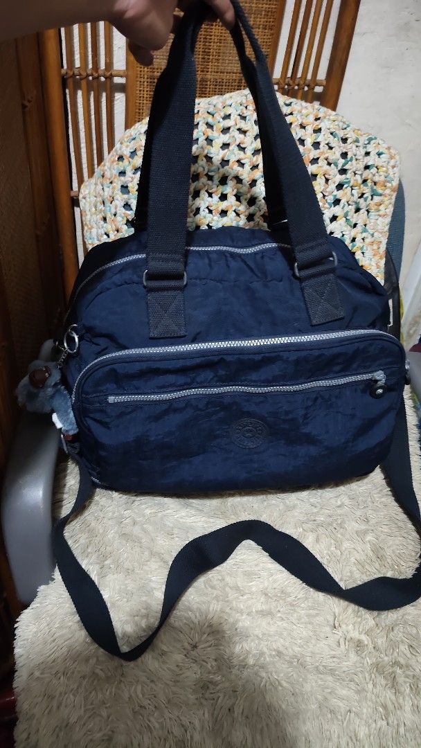 Kipling Navy Blue Nylon (Category: Cross-body Bags) located in Cebu City. Submitted by lumaynojes00490 (Listing ID 1463956741, Image 1). Description: large to XL size... expandable not faded..10/10 color rate - Navy blue Kipling bag - Made of durable nylon - Main compartment - Front zippered pocket - Top handles - Detachable shoulder strap - Includes signature Kipling monkey charm - Ideal for everyday use or travel.