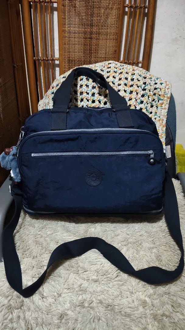Kipling Navy Blue Nylon (Category: Cross-body Bags) located in Cebu City. Submitted by lumaynojes00490 (Listing ID 1463956741, Image 3). Description: large to XL size... expandable not faded..10/10 color rate - Navy blue Kipling bag - Made of durable nylon - Main compartment - Front zippered pocket - Top handles - Detachable shoulder strap - Includes signature Kipling monkey charm - Ideal for everyday use or travel.
