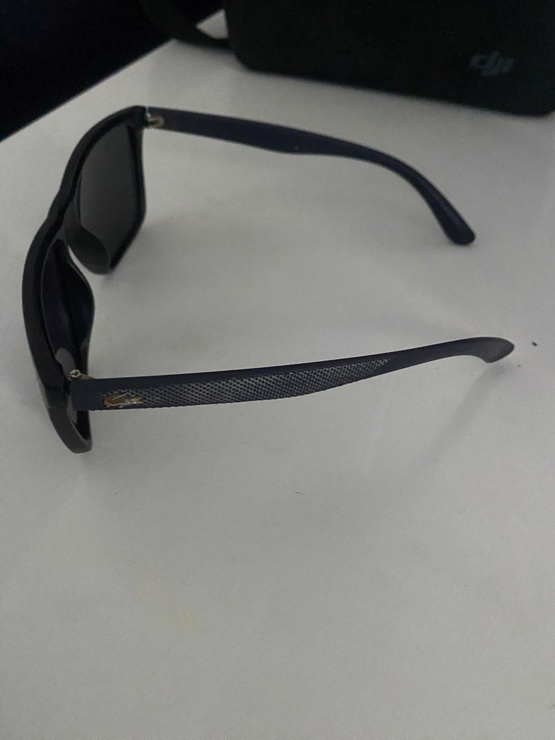 Lacoste Black Sunglasses (Category: Sunglasses & Eyewear) located in Mandaluyong City. Submitted by janleevee (Listing ID 1463957179, Image 2). Description: - Classic black Lacoste sunglasses - Subtle croc logo on the side - Dark lenses - Suitable for everyday wear - Comes with a case.