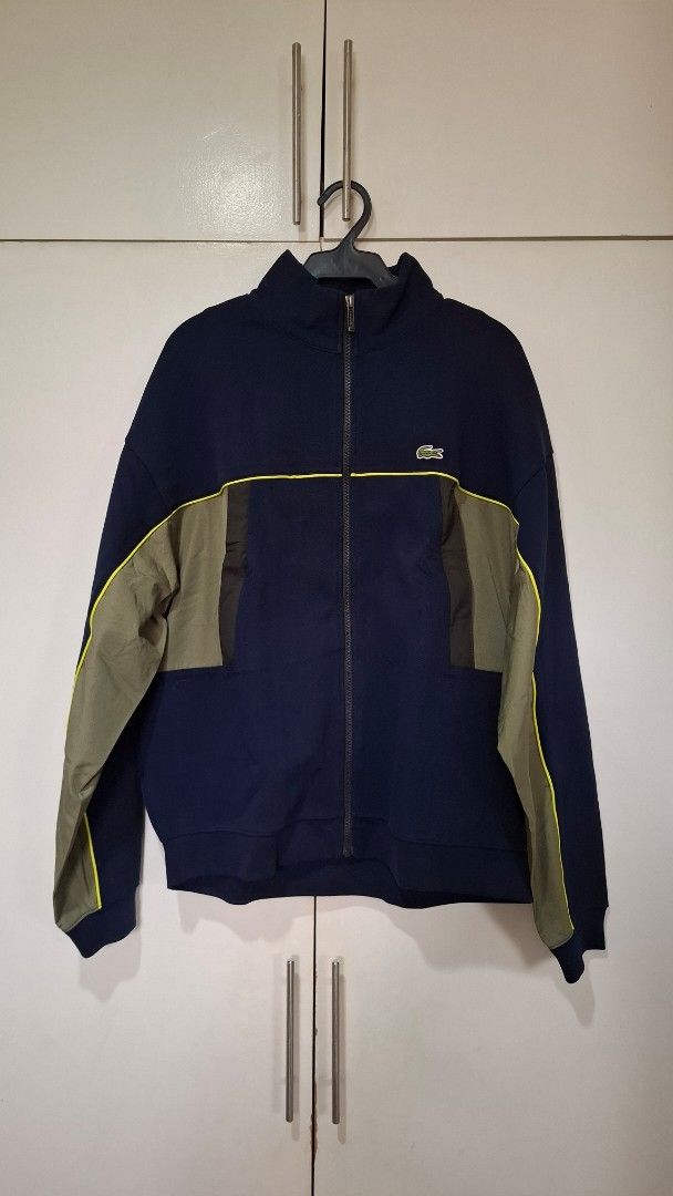 Lacoste Brand New with Tags Navy Jacket (Category: Coats, Jackets and Outerwear) located in Quezon City. Submitted by mmmegg (Listing ID 1463957517, Image 2). Description: Brand new with tags and bag. Loose fit. Navy, with olive green detailing. Option is also to trade-in. We can negotiate. MoP: GCash or online banking Delivery: from QC. J&T or LBC.