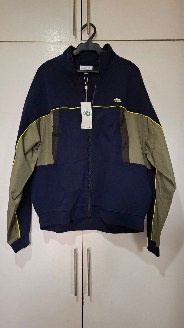 Lacoste Brand New with Tags Navy Jacket (Category: Coats, Jackets and Outerwear) located in Quezon City. Submitted by mmmegg (Listing ID 1463957517, Image 1). Description: Brand new with tags and bag. Loose fit. Navy, with olive green detailing. Option is also to trade-in. We can negotiate. MoP: GCash or online banking Delivery: from QC. J&T or LBC.
