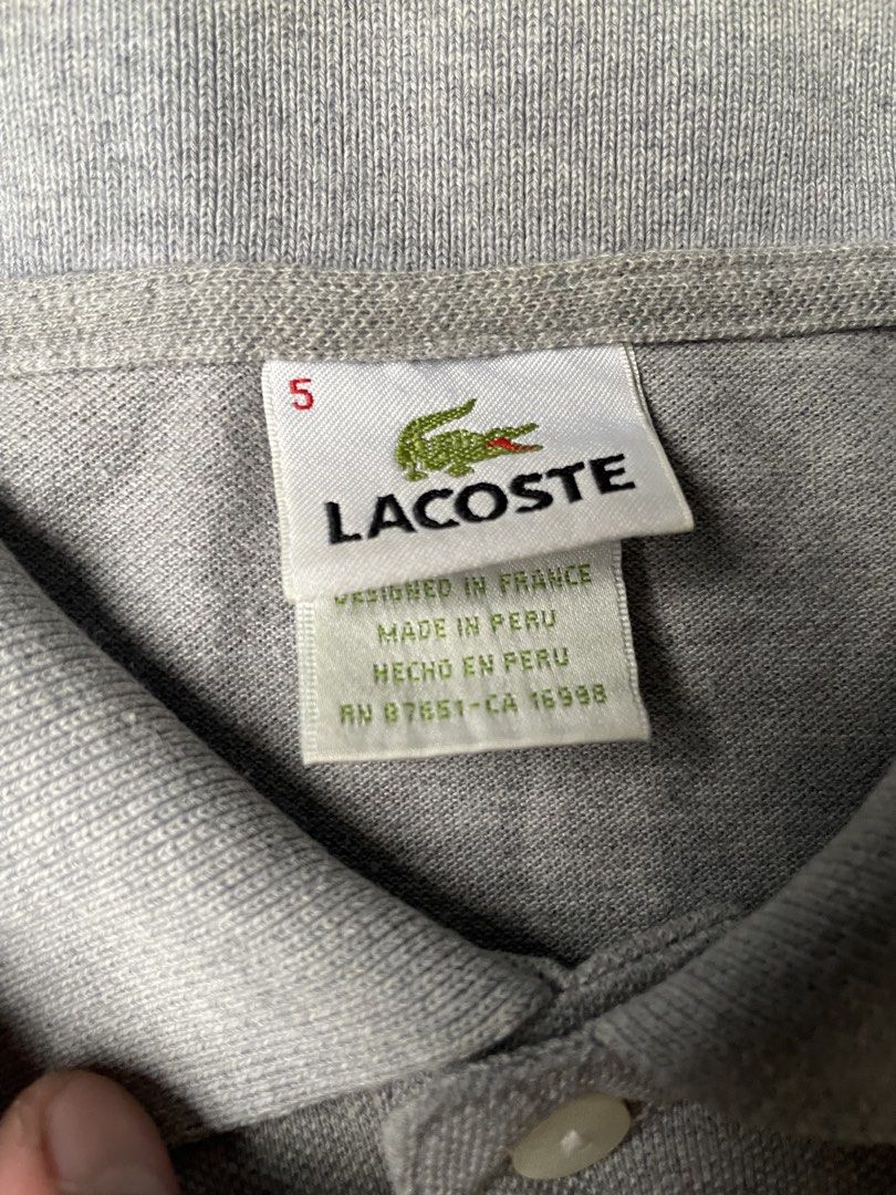 Lacoste Polo Shirt Size S Grey (Category: Tshirts & Polo Shirts ) located in Siniloan. Submitted by rethr1ft (Listing ID 1463969094, Image 2). Description: - 27x20 Dimes - Grey Lacoste Polo Shirt - Size: M - Classic short-sleeve design - Two-button placket - Iconic crocodile logo - Designed in France, Made in Peru - Ideal for casual wear.
