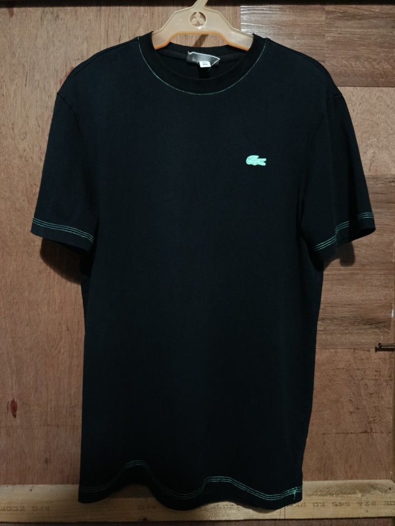 Lacoste Regular Fit Black T-Shirt (Category: Tshirts & Polo Shirts ) located in Bolinao. Submitted by joshuathrift (Listing ID 1464076109, Image 2). Description: - Authentic Black Lacoste T-shirt - Size: Medium (FR 4) - Iconic green crocodile logo embroidered on the chest - Stylish contrast stitching on collar, sleeves, and hem - Regular fit, ideal for everyday casual wear.
