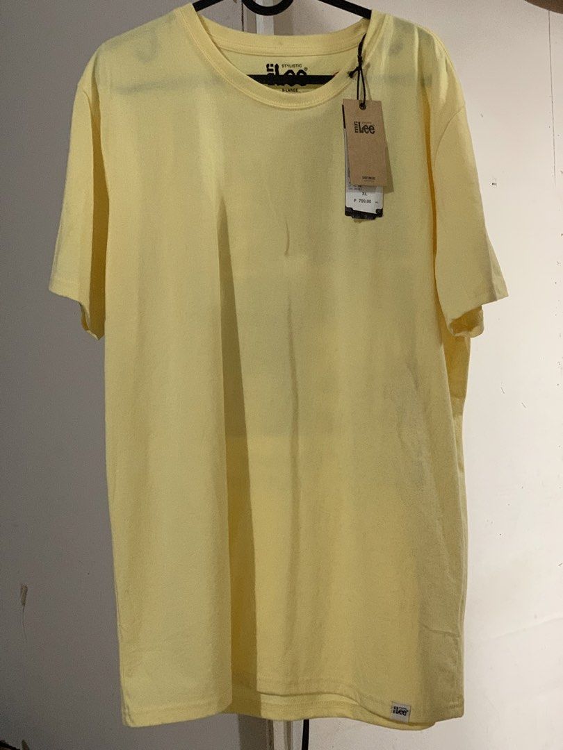 Lee Stylistic Yellow Ringer T-Shirt (Category: Shirts) located in San Mateo. Submitted by kusinaninanan (Listing ID 1464011504, Image 2). Description: - Brand: Lee Stylistic - Color: Yellow - Style: Ringer Tee - Features: Graphic print on back ("Forever Authentic", "Makers of Durable Garments") - Condition: Brand new with original tags attached - Material: Comfortable jersey - Ideal for: Casual wear.