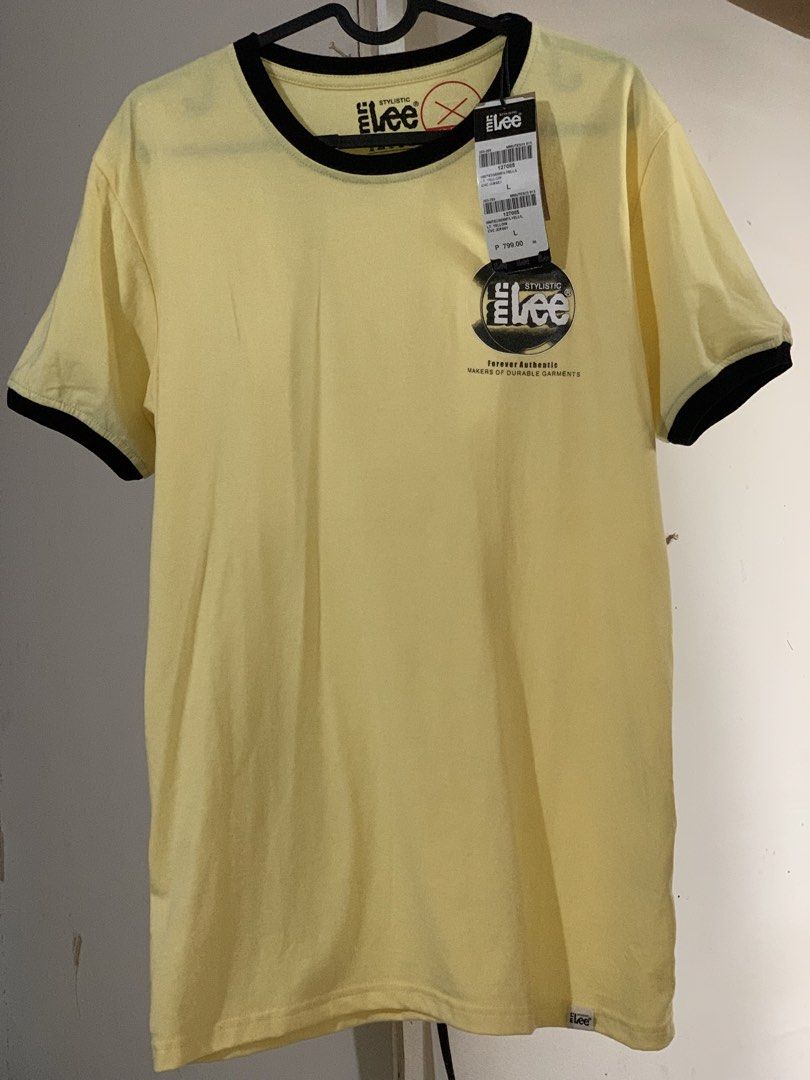 Lee Stylistic Yellow Ringer T-Shirt (Category: Shirts) located in San Mateo. Submitted by kusinaninanan (Listing ID 1464011504, Image 1). Description: - Brand: Lee Stylistic - Color: Yellow - Style: Ringer Tee - Features: Graphic print on back ("Forever Authentic", "Makers of Durable Garments") - Condition: Brand new with original tags attached - Material: Comfortable jersey - Ideal for: Casual wear.