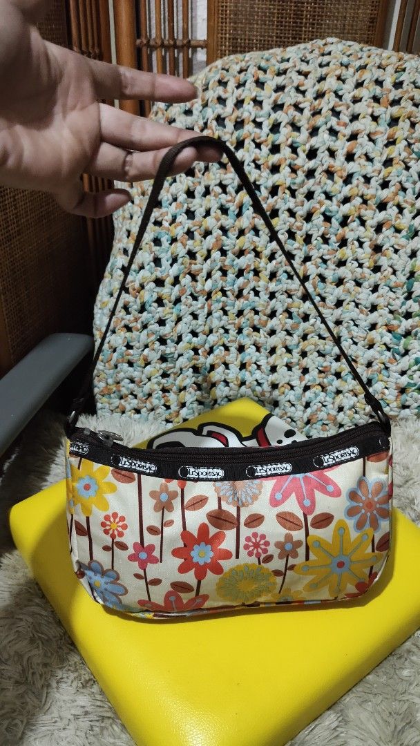 LeSportsac Floral Shoulder Bag (Category: Shoulder Bags) located in Cebu City. Submitted by lumaynojes00490 (Listing ID 1463962274, Image 1). Description: - Cute LeSportsac shoulder bag - Fun floral print - Dark brown strap - Compact size for essentials - Secure zipper closure - Ideal for everyday or casual outings - Adds a pop of color to your outfit.