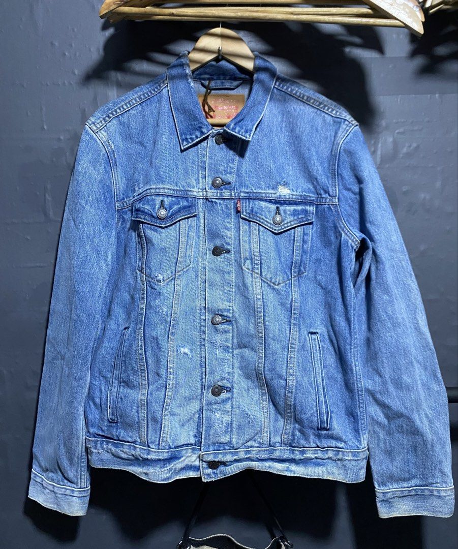 Levi's Denim Jacket - Blue - Size M (Category: Coats, Jackets and Outerwear) located in Antipolo. Submitted by drop.thrifts (Listing ID 1463961889, Image 1). Description: - Classic blue Levi's denim jacket - Made in Thailand - 100% Cotton - Iconic red tab and button closure - Subtle distressed details on fabric - Ideal for layering - Dimes: 20.5x25.5 - 1,200 free shipping .