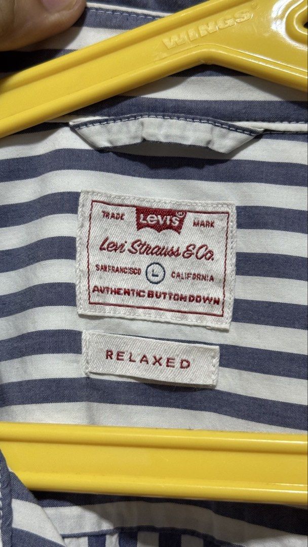 Levi's Striped Button-Down Shirt Relaxed Fit (Category: Shirts) located in Bacoor. Submitted by jiricu1 (Listing ID 1464079577, Image 2). Description: - Classic Levi's button-down shirt - Navy and white vertical stripes - Relaxed fit, Size L - 100% Cotton - Button closure at front and cuffs - Ideal for casual wear.