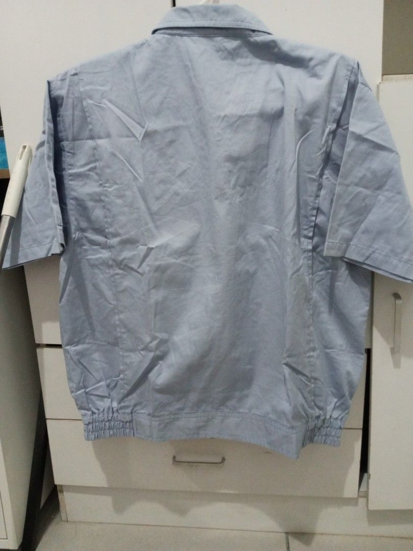 Light Blue Short Sleeve Work Jacket MB Logo (Category: Coats, Jackets and Outerwear) located in Manila. Submitted by lofiley (Listing ID 1464031096, Image 2). Description: - Light blue short sleeve jacket - Two chest pockets with button closures - Elasticated hem for a comfortable fit - Small MB logo embroidered on the chest - Versatile for work or casual occasions.