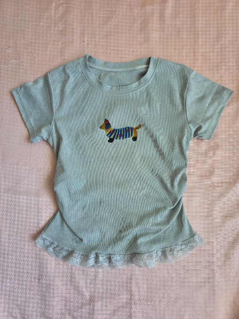 Light Grey T-shirt with Printed Dachshund (Category: Shirts) located in Manila. Submitted by findsbynie (Listing ID 1463954369, Image 1). Description: - Light grey t-shirt - Ribbed texture all over - Small printed dachshund detail on front - Delicate lace trim on sleeves and hem - Comfortable and stylish design.