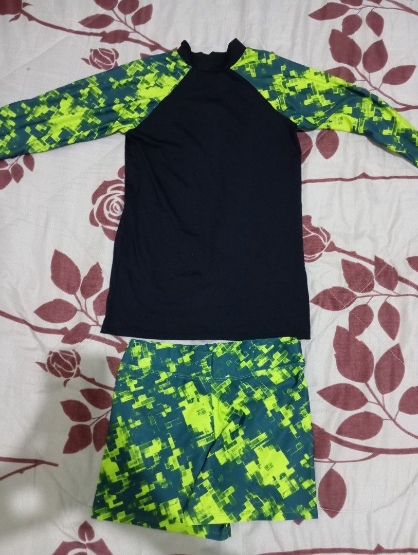 Long sleeve rash guard and shorts set (Category: Rash guard) located in Dasmarinas. Submitted by kei05 (Listing ID 1463958463, Image 1). Description: - Long sleeve rash guard top - Matching shorts - Black top with bright green and dark teal geometric sleeves - Geometric patterned shorts - Ideal for swimming and water sports - Comfortable and quick-drying fabric.