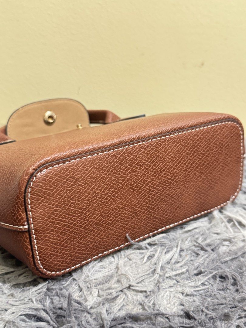 Longchamp epure (Category: Luxury Bags & Wallets) located in Batangas. Submitted by bagsbyann (Listing ID 1463944392, Image 3). Description: - Genuine brown leather handbag - Versatile: Top handles and detachable shoulder strap - Organized interior: Main compartment and a small pocket - Secure closure: Snap button on the flap - Bonus: Comes with a matching leather luggage tag - Ideal for daily use.