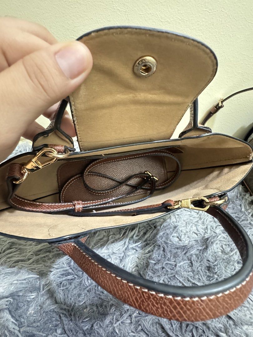 Longchamp epure (Category: Luxury Bags & Wallets) located in Batangas. Submitted by bagsbyann (Listing ID 1463944392, Image 2). Description: - Genuine brown leather handbag - Versatile: Top handles and detachable shoulder strap - Organized interior: Main compartment and a small pocket - Secure closure: Snap button on the flap - Bonus: Comes with a matching leather luggage tag - Ideal for daily use.