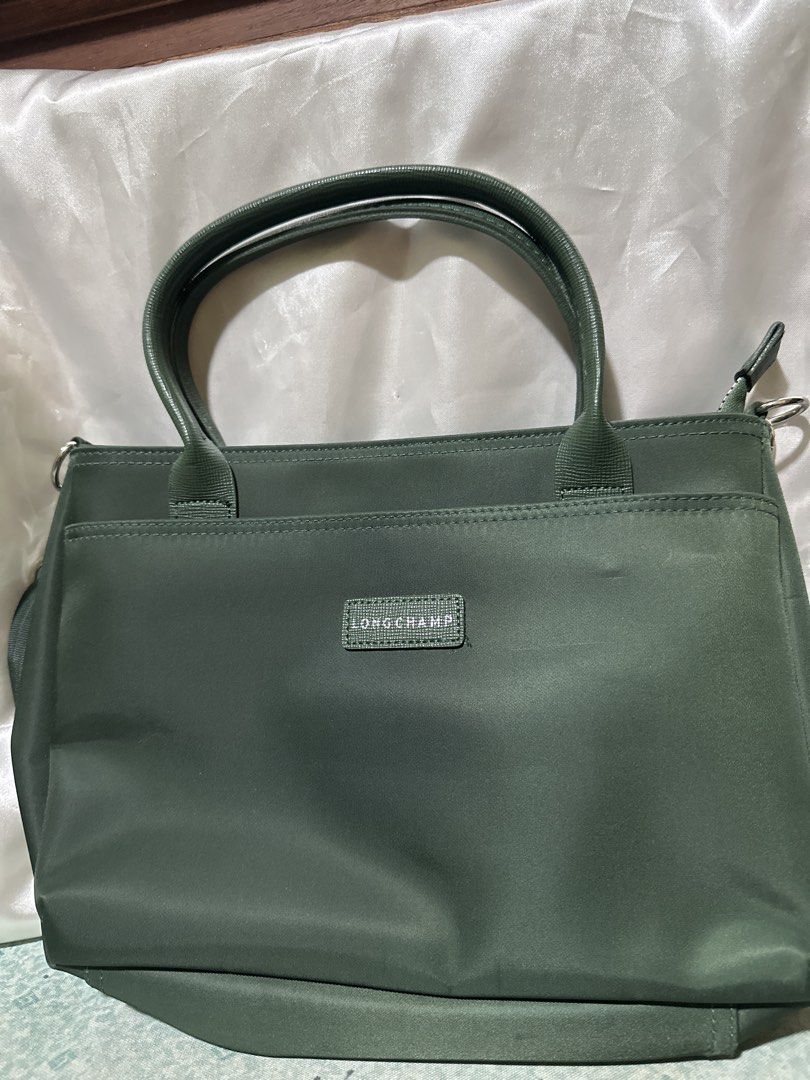 Longchamp Green Nylon Tote Bag (Category: Luxury Bags & Wallets) located in Balanga. Submitted by jk2025. (Listing ID 1463962179, Image 1). Description: - Authentic Green Longchamp Tote Bag - Made from durable nylon - Features top handles and a detachable shoulder strap - Includes a spacious main compartment - Has convenient exterior pockets - Ideal for everyday use and travel.
