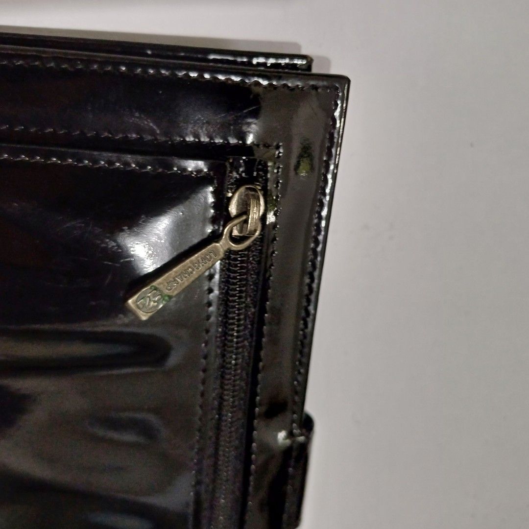 Longchamp Patent Leather Wallet (Category: Wallets & Card holders) located in Pasig City. Submitted by padillaaub64242 (Listing ID 1463974157, Image 3). Description: - Brand: Longchamp - Material: Black patent leather - Features: Multiple card slots, zippered compartment - Closure: Snap closure.