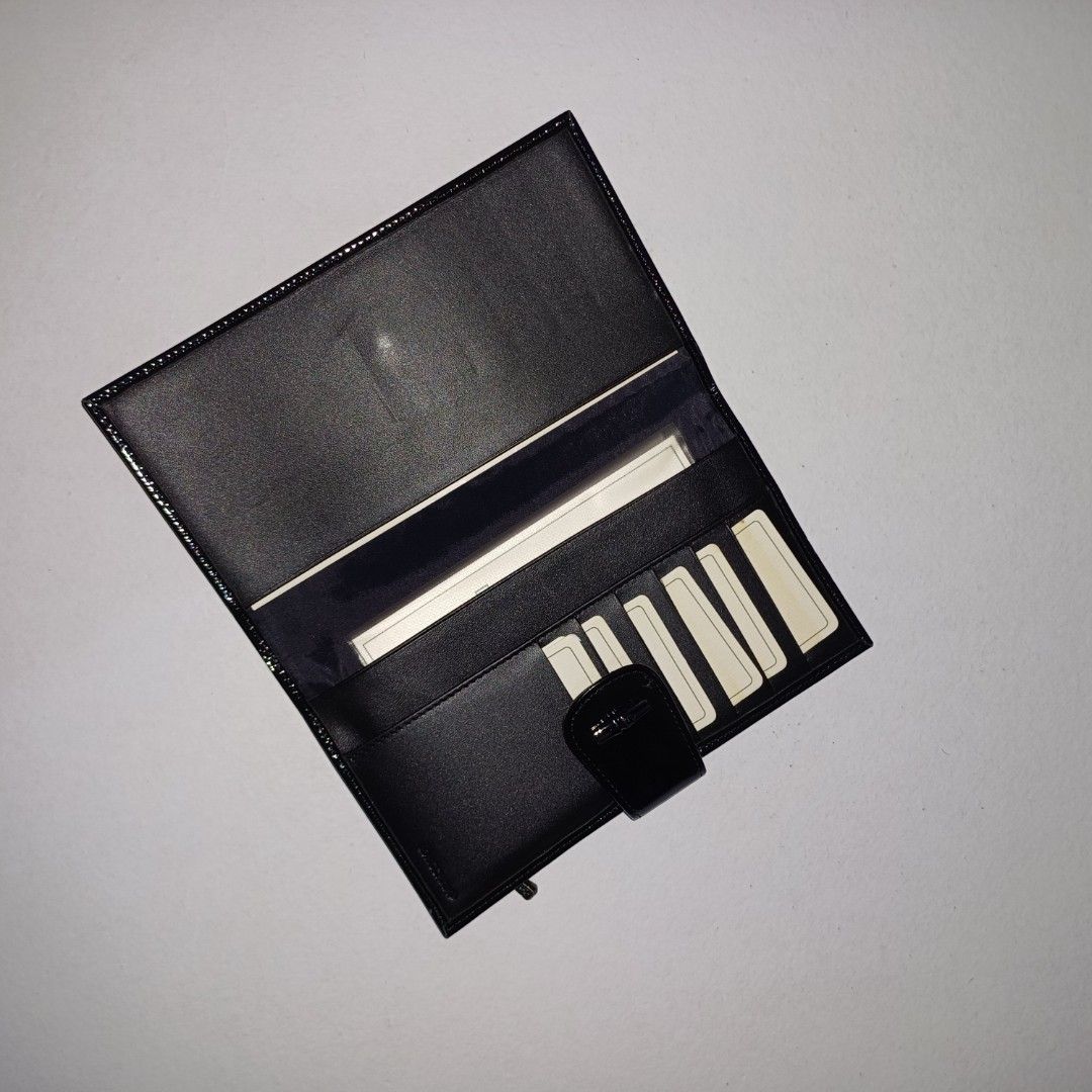 Longchamp Patent Leather Wallet (Category: Wallets & Card holders) located in Pasig City. Submitted by padillaaub64242 (Listing ID 1463974157, Image 2). Description: - Brand: Longchamp - Material: Black patent leather - Features: Multiple card slots, zippered compartment - Closure: Snap closure.