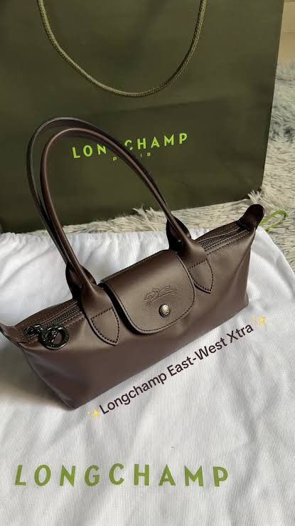 Longchamp Shoulder Bag (Category: Luxury Bags & Wallets) located in Paoay. Submitted by rvf1230 (Listing ID 1464133357, Image 1). Description: - Authentic Brown Longchamp Le Pliage East-West Xtra bag - Genuine leather handles and trim - Secure zipper closure with snap button flap - Comes with original dust bag - Ideal for daily use and errands.