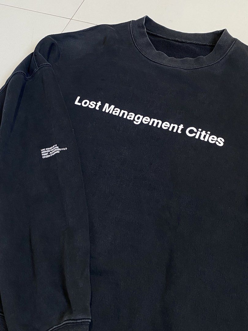 Lost Management Cities Black Graphic Sweatshirt (Category: Coats, Jackets and Outerwear) located in Baguio. Submitted by yunothewizardking (Listing ID 1463946934, Image 1). Description: - Black sweatshirt from Lost Management Cities (LMC) - Features 'Lost Management Cities' graphic on the front - Label reads 'LMC Designs for the Contemporaries of Our City and Time' - Made in 2015 - Crewneck style with long sleeves - Ideal for casual wear.