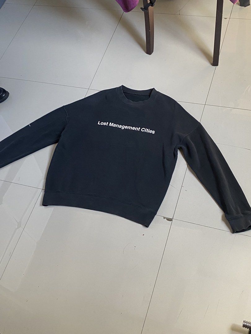 Lost Management Cities Black Graphic Sweatshirt (Category: Coats, Jackets and Outerwear) located in Baguio. Submitted by yunothewizardking (Listing ID 1463946934, Image 2). Description: - Black sweatshirt from Lost Management Cities (LMC) - Features 'Lost Management Cities' graphic on the front - Label reads 'LMC Designs for the Contemporaries of Our City and Time' - Made in 2015 - Crewneck style with long sleeves - Ideal for casual wear.