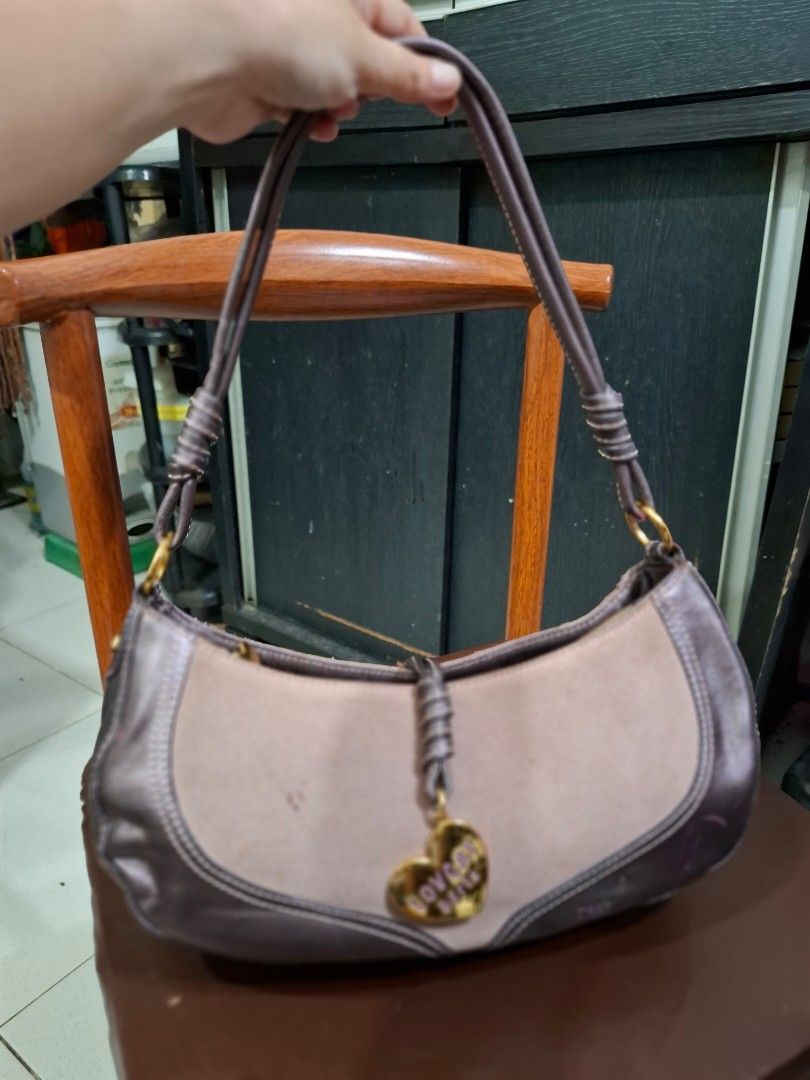 lovcat Heart Charm Shoulder Bag (Category: Shoulder Bags) located in Cavite. Submitted by mahthriftshop (Listing ID 1463982860, Image 1). Description: - Cute Lovcat shoulder bag - Signature heart charm included - Zipper closure for security - Adjustable strap for comfort - Ideal for everyday use - Minor signs of wear on leather trim.