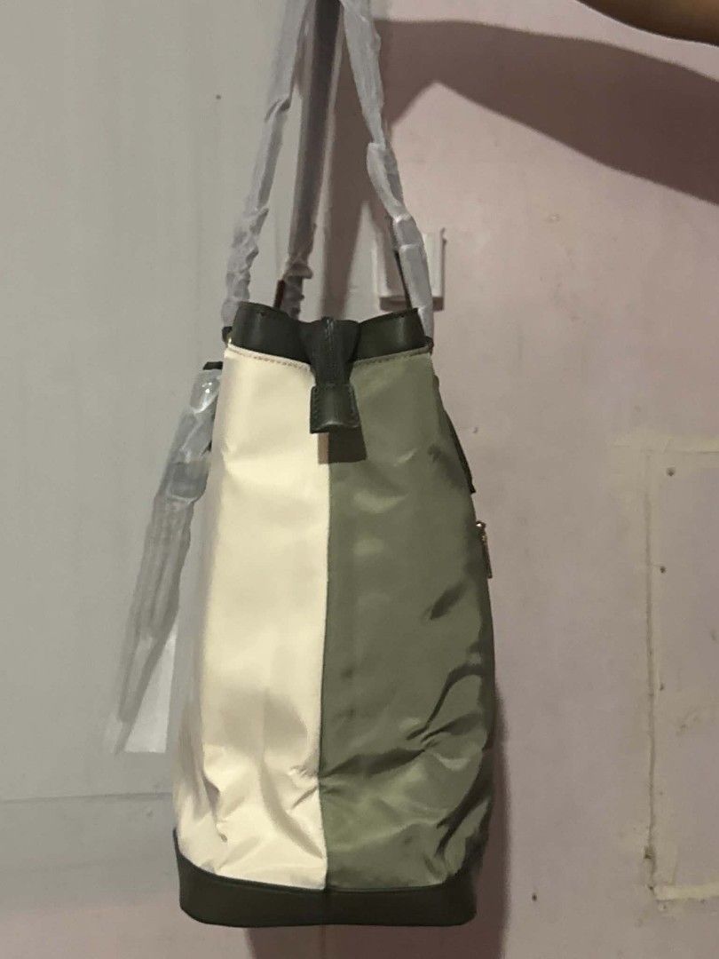 LOVEVOOK Tote Bag (Category: Tote Bags) located in Manila. Submitted by vsballeras1984 (Listing ID 1464066965, Image 3). Description: - LOVEVOOK colorblock tote bag - Stylish olive green and cream panels - Convenient zippered back pocket - Includes a matching pouch - Handles still wrapped in original plastic - Ideal for everyday use.